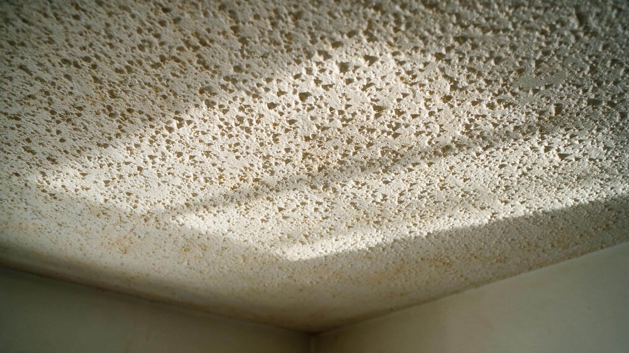 Popcorn ceiling asbestos: the years, the test, and what not to touch