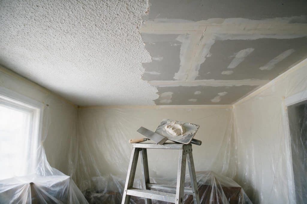 Ceiling half scraped down to bare drywall and half still covered in popcorn texture